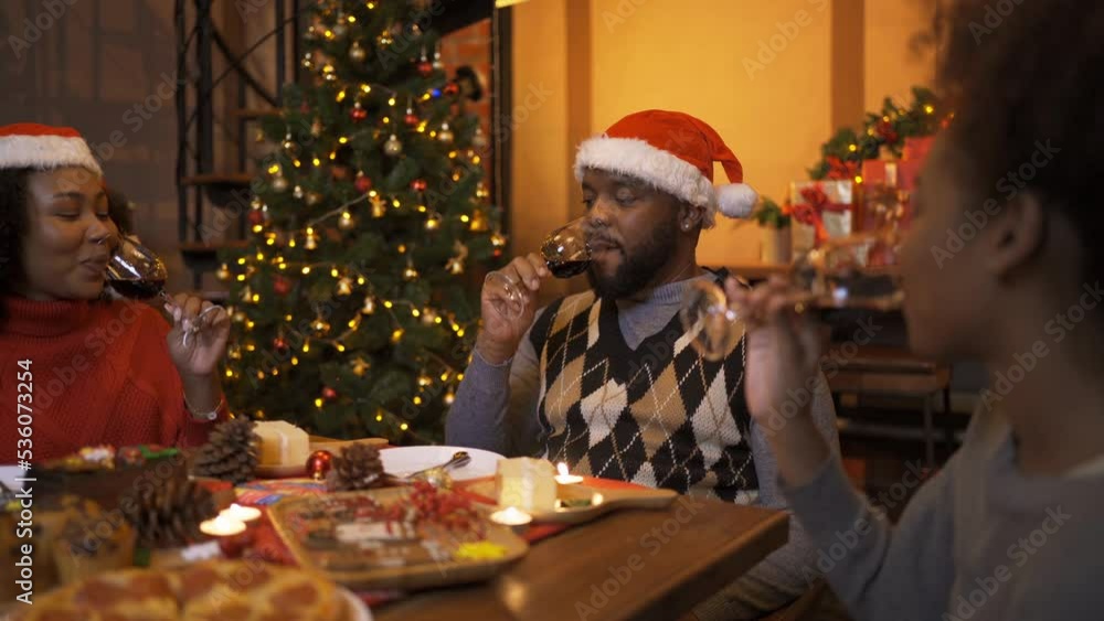 A group of African American black family, women girl have a celebration dinner in party on Merry Christmas Eve Xmas on holiday at home or house. People lifestyle. Happy New Year A group of African American black family, women girl have a celebration dinner in party on Merry Christmas Eve Xmas on holiday at home or house. People lifestyle. Happy New Year
