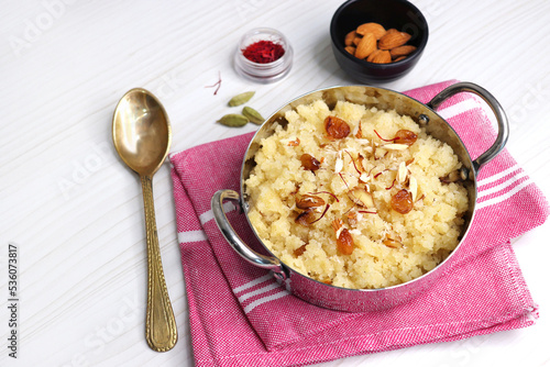 Rava Sheera or Suji ka halwa, shira is an indian sweet dish, made with semolina, sugar, ghee and dry fruits.  served as dessert or as Prasad during festivals. Garnished with saffron. Copy space. photo