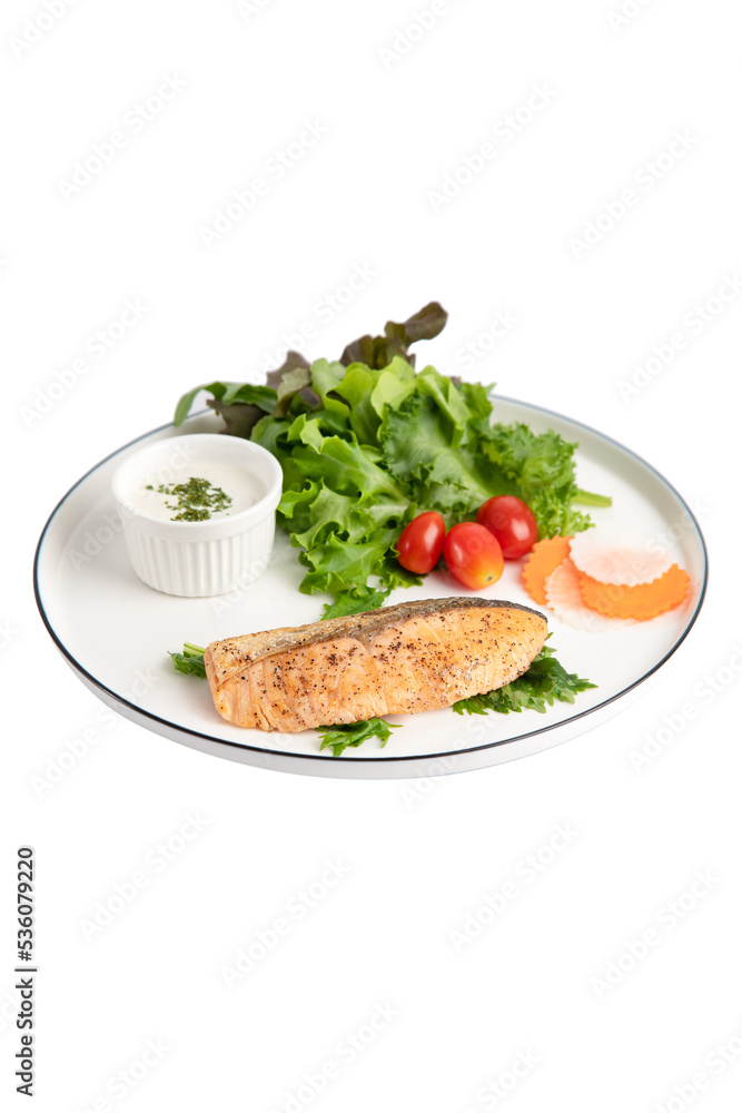 Fried salmon steaks with vegetables on white background isolated Fried salmon steaks with vegetables on white background isolated