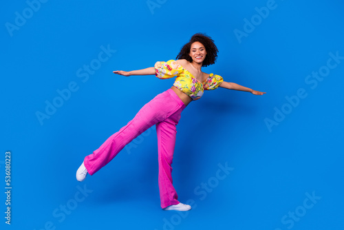 Fototapeta Naklejka Na Ścianę i Meble -  Full size portrait of excited cheerful lady arms wings enjoy good mood isolated on blue color background