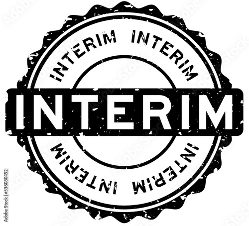 Grunge black interim word round rubber seal stamp on white background