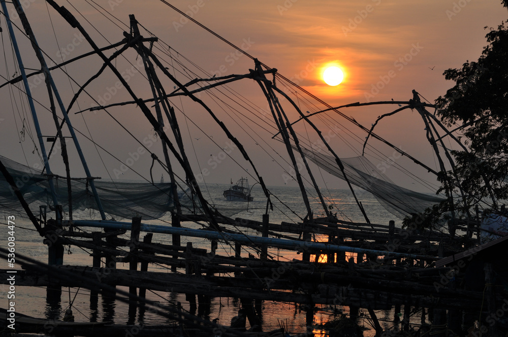 Sunset through the traditional Chinese fishing net at Fort Kochi ,at Kerala, India 