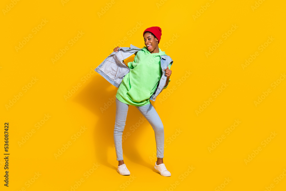 Full length body size view of attractive cheerful funky girl enjoying having fun dancing isolated over bright yellow color background Full length body size view of attractive cheerful funky girl enjoying having fun dancing isolated over bright yellow color background