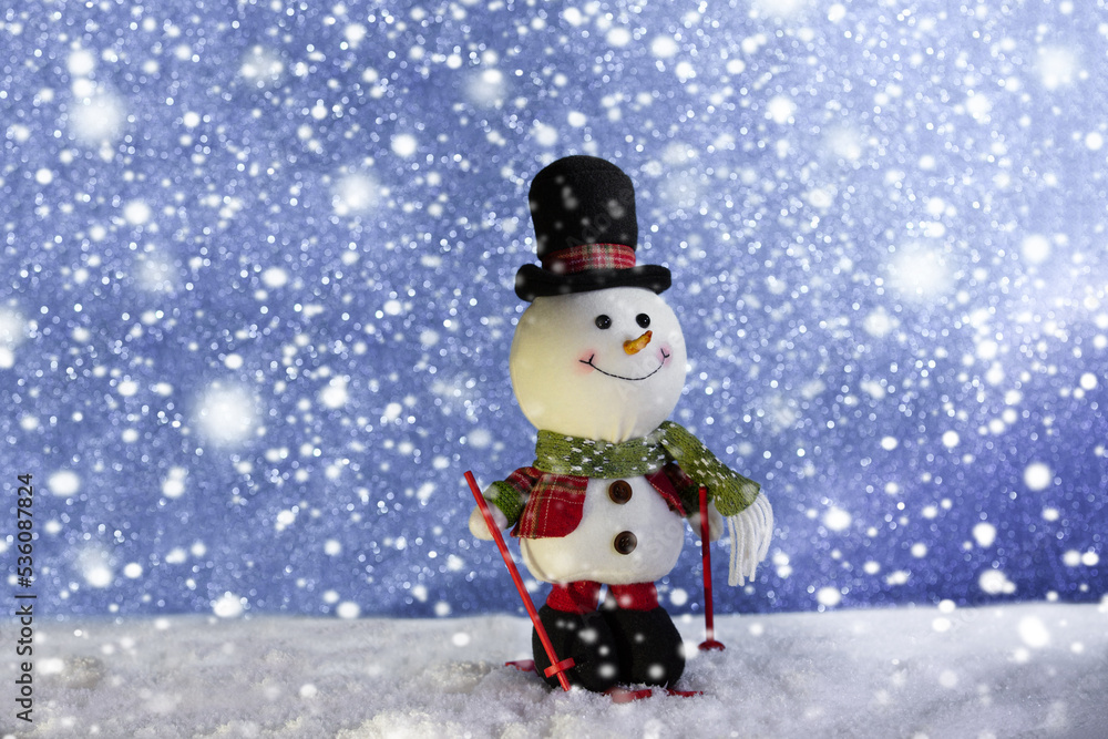 Happy snowman standing in winter sparkling christmas landscape. Merry christmas and happy new year greeting card with copy space .Snow background.