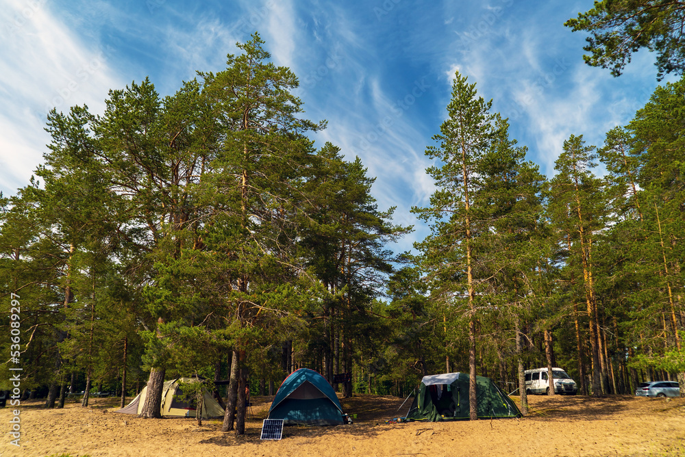 Tents on the sandy beach among the pines. Lake Ladoga . Karelia Tents on the sandy beach among the pines. Lake Ladoga . Karelia