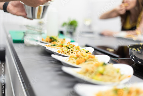 Row of served plates with ready dishes at cooking workshop photo