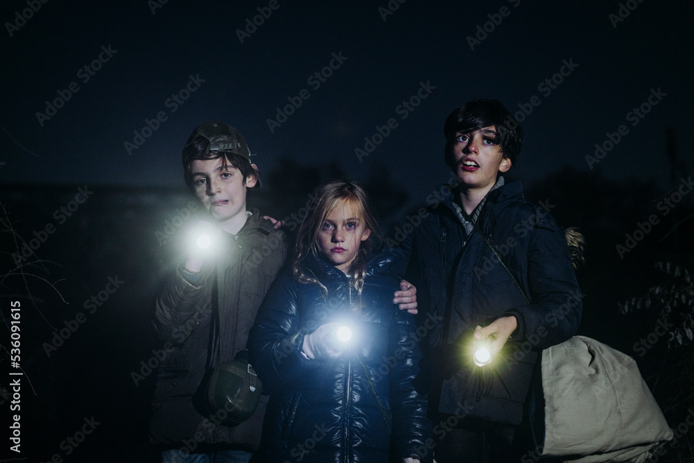 Children camping and playing with torch lantern in the dark Children camping and playing with torch lantern in the dark