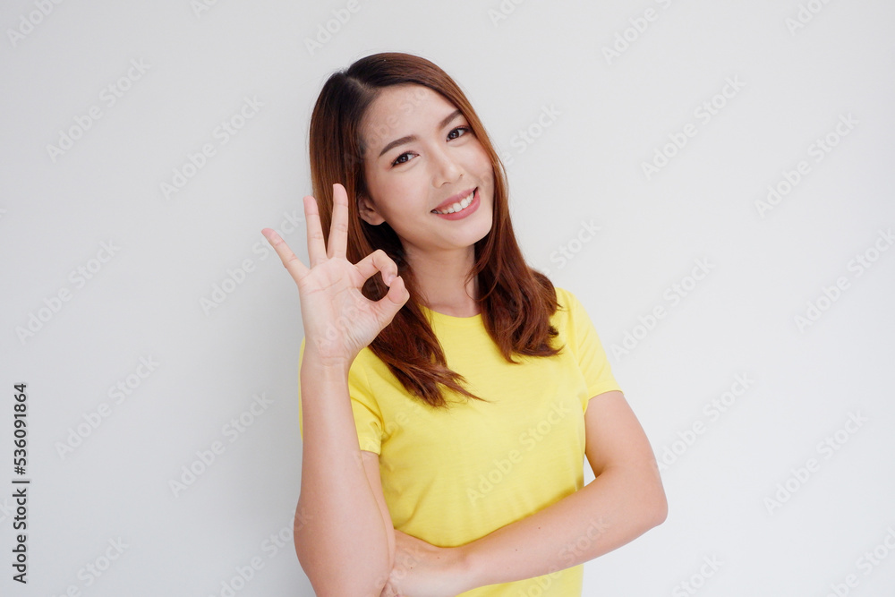 beautiful woman smiling showing ok hand. beautiful woman smiling showing ok hand.