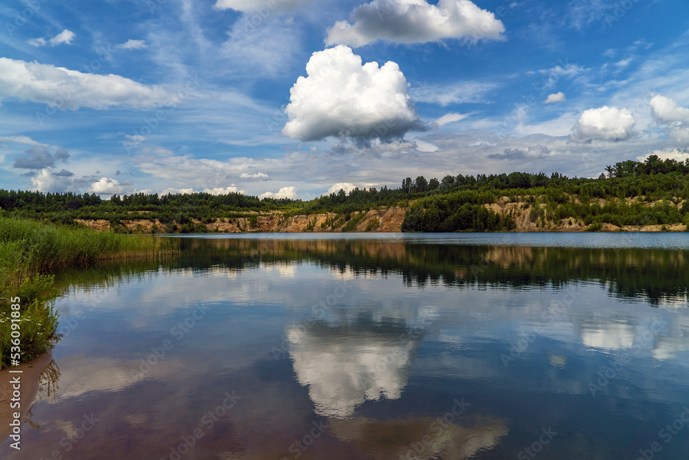 A large white cloud over the lake water.