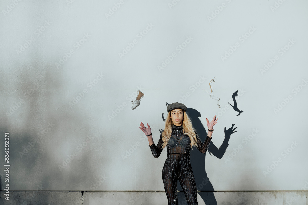 Young black woman throwing her shoes in the air Young black woman throwing her shoes in the air