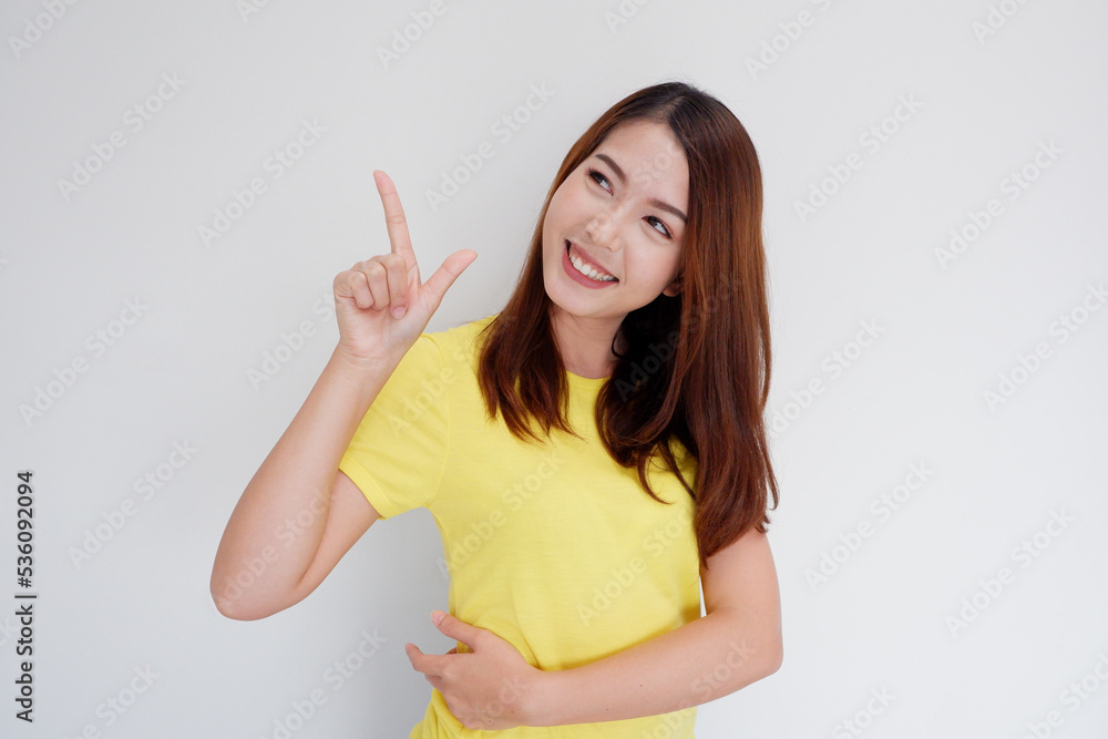 Fototapeta premium smiling girl pointing finger to present