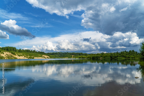Fototapeta Naklejka Na Ścianę i Meble -  Beautiful sky with white clouds over the water surface .