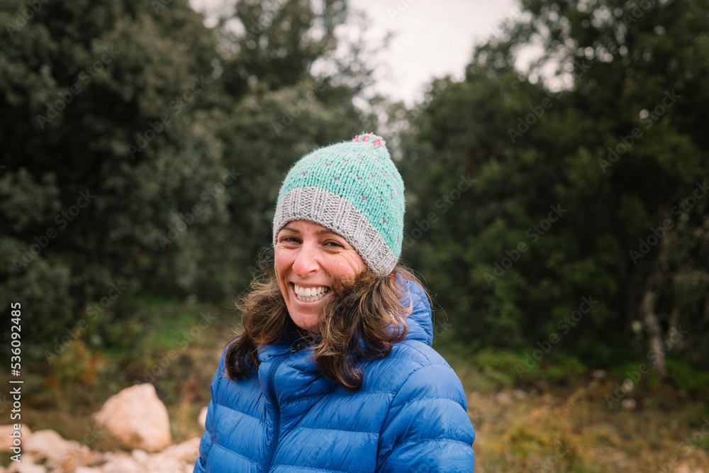 Smiling woman in hat in green fresh forest Smiling woman in hat in green fresh forest