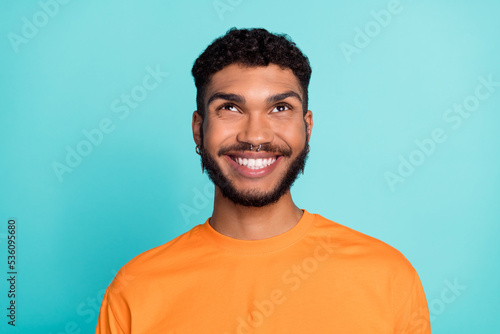 Close up photo of cheerful attractive man interested look empty space cool proposition offer big sale isolated on cyan color background