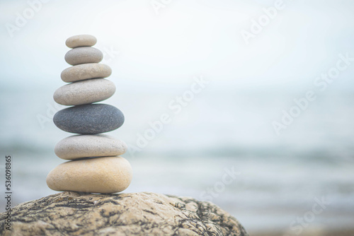 Pebble tower balance harmony stones arrangement on sea beach coastline peaceful formation pyramid
