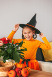 Little Girl Playing With a Pumpkin. emotional portrait  at home. Halloween party concept. 