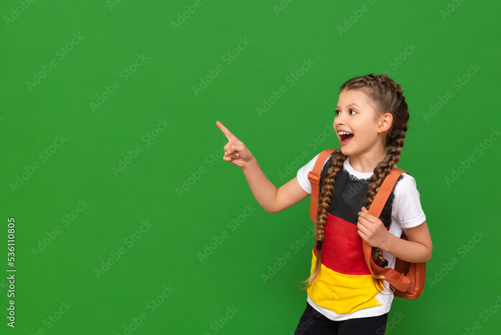 Studying abroad, learning German, a little girl with textbooks and a briefcase on an isolated background. Studying abroad, learning German, a little girl with textbooks and a briefcase on an isolated background.