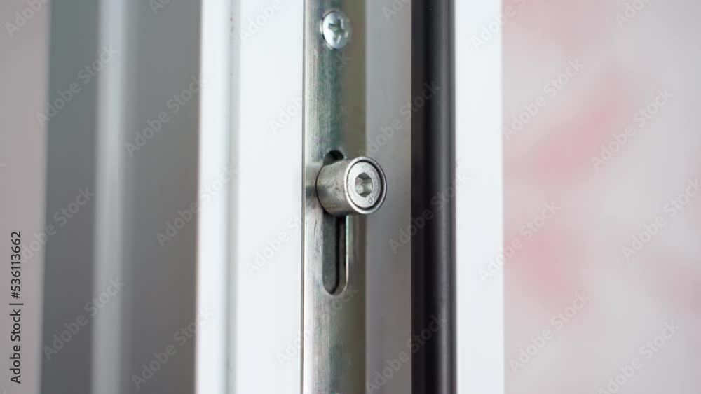 Close-up of the movement of plastic door fittings. The mechanism for blocking plastic windows when turning the handle. Close-up of the movement of plastic door fittings. The mechanism for blocking plastic windows when turning the handle.