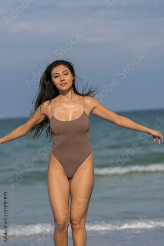 Fototapeta Naklejka Na Ścianę i Meble -  Lovely Mixed Race Bikini Model Posing Outdoors On A Caribbean Beach