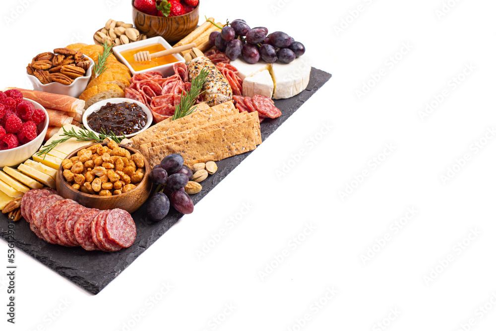 Meat Cheese and Fruit Charcuterie Board on a White Background Meat Cheese and Fruit Charcuterie Board on a White Background