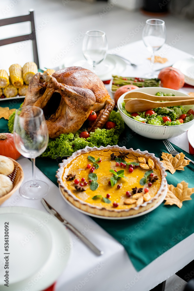 delicious roasted turkey near traditional pumpkin pie with cranberries and mint leaves served for thanksgiving dinner delicious roasted turkey near traditional pumpkin pie with cranberries and mint leaves served for thanksgiving dinner