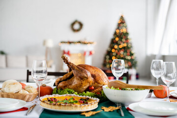 pumpkin pie with cranberries near roasted turkey and fresh vegetable salad served for thanksgiving dinner