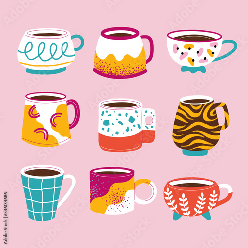 A set of colorful handmade mugs. Colored cups with coffee and tea. Painting of ceramic dishes