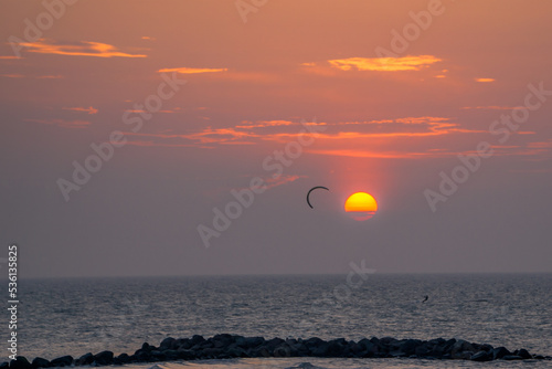 Fototapeta Naklejka Na Ścianę i Meble -  A kiter in front of a scenic sunset