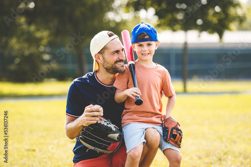 Photography Father and son playing baseball in sunny day at public park