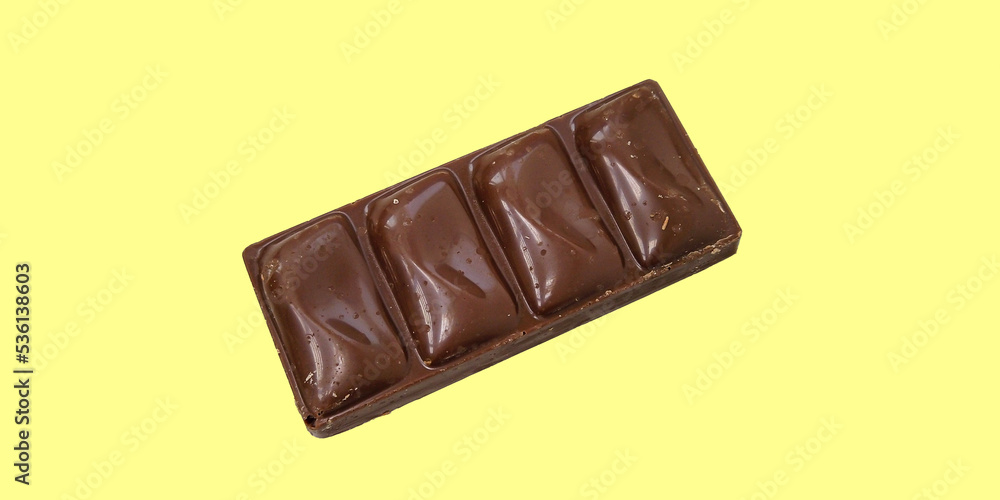 Obraz premium Chocolate bar isolated on a yellow background. Milk chocolate