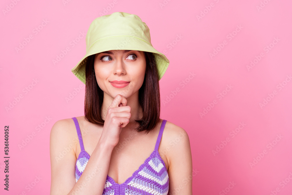 Photo of minded charming lady arm finger touch chin look interested empty space isolated on pink color background Photo of minded charming lady arm finger touch chin look interested empty space isolated on pink color background