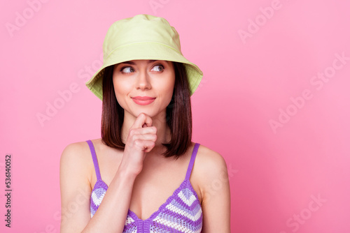 Photo of minded charming lady arm finger touch chin look interested empty space isolated on pink color background