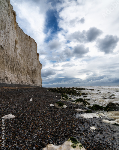 rocky beach at Birling Gap with the cliffs of the Seven Sisters in the background on the Jurassic Coast of East Sussex photo