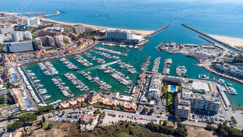 Beautiful aerial perspective of Vilamoura marina. Luxury hotels, yachts docked in the port. Famous travel destination in south of Portugal. Algarve region