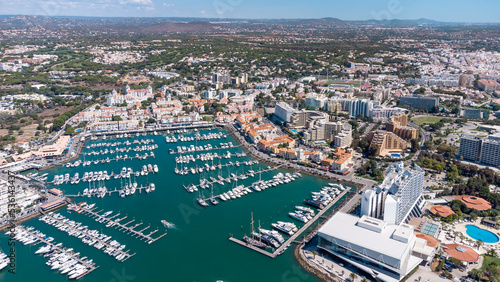 Beautiful aerial perspective of Vilamoura marina. Luxury hotels, yachts docked in the port. Famous travel destination in south of Portugal. Algarve region photo