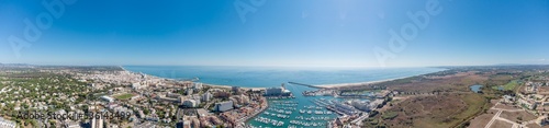 Sensational panorama of beautiful Vilamoura city. Luxury hotels, yachts docked in the port. Famous travel destination in south of Portugal - Algarve region. View of the city and the port area