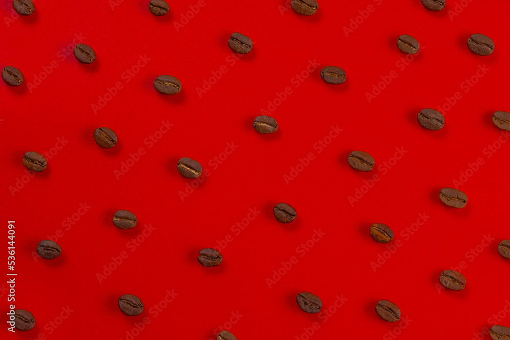 Red background with coffee beans top view Red background with coffee beans top view