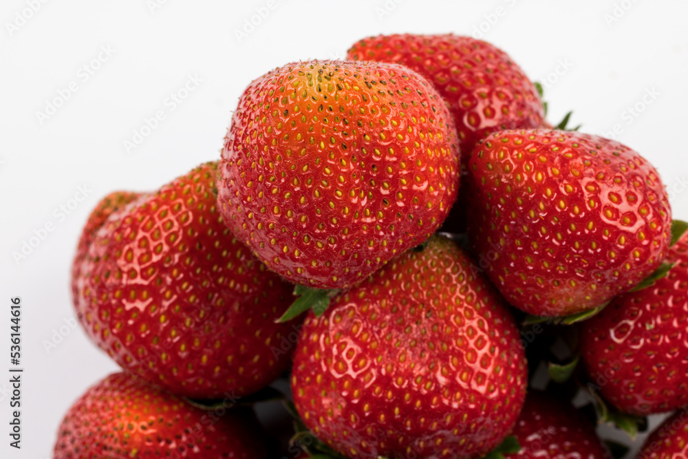 Ripe and juicy red strawberries on white background. Ripe and juicy red strawberries on white background.