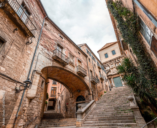 Fototapeta Naklejka Na Ścianę i Meble -  Beautiful streets of Girona old town with ancient buildings and cobblestone stairways, Spain
