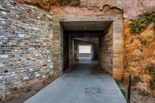 Fototapeta Naklejka Na Ścianę i Meble -  Entrance tunnel through the city wall to L'Aldilonda, a walkway along the rocky east coast of Corsica below the citadel of Bastia