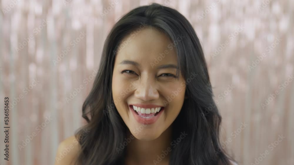 Slow motion shot, Young asian woman looking to camera and smile at party event. Party, Celebration, Happiness concept. Slow motion shot, Young asian woman looking to camera and smile at party event. Party, Celebration, Happiness concept.