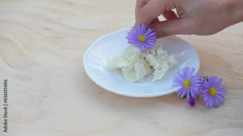 unrefined shea butter, a natural moisturizing cosmetic,
with purple flowers unrefined shea butter, a natural moisturizing cosmetic,
with purple flowers