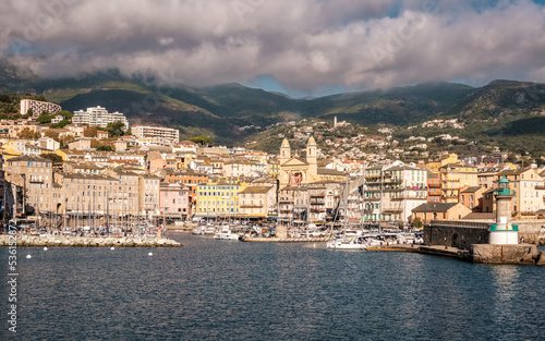 Fototapeta Naklejka Na Ścianę i Meble -  Entrance to the old port and the city of Bastia on the east coast of Corsica with mountains in the distance