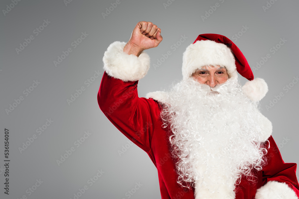 Santa claus in costume showing yes gesture isolated on grey.