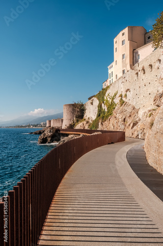 Fototapeta The L'Aldilonda walkway along the rocky east coast and city wall below the citad