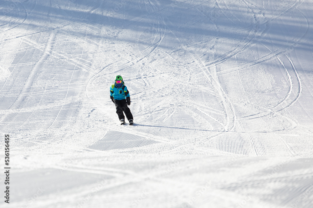 A child while skiing in a ski resort.
