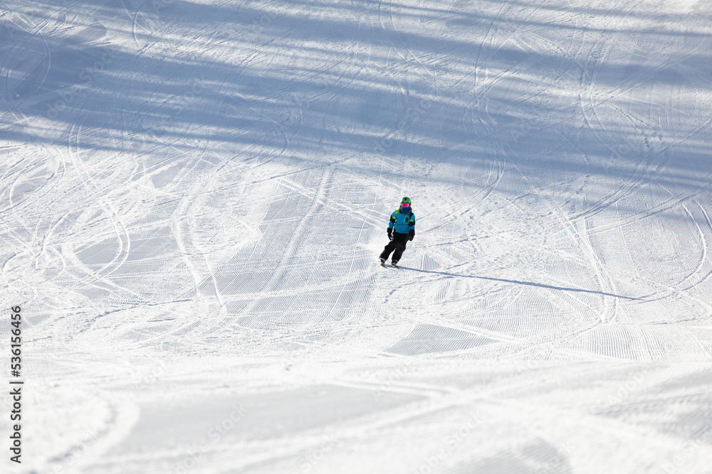 A child while skiing in a ski resort.