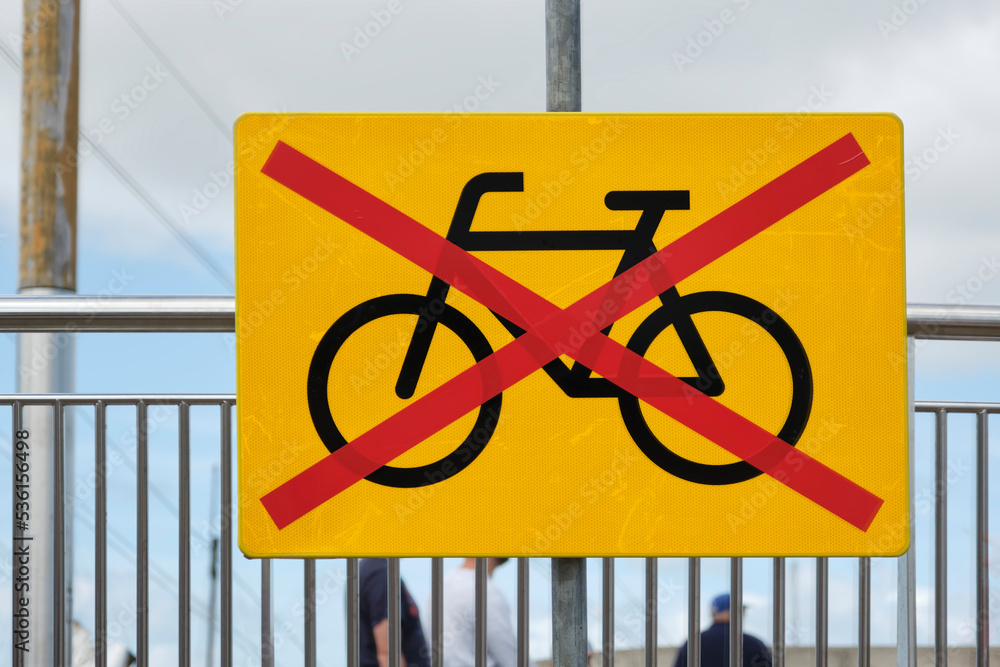No bicycle entry sign. Improvised rectangular yellow sign with bike and