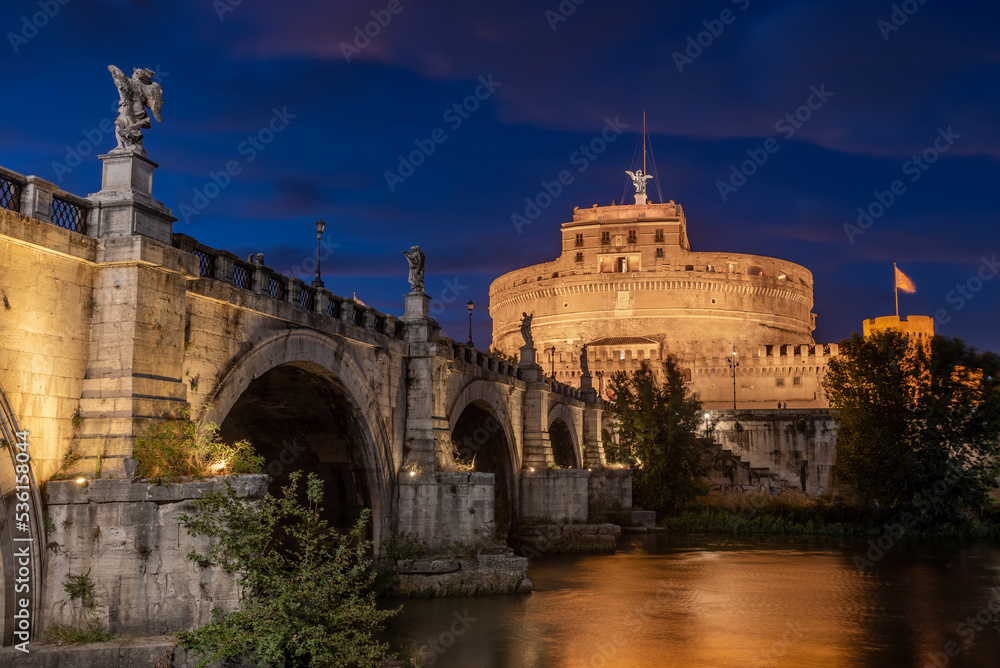 Long Exposition at Blue Hour of The Saint Angel's Castle and a Bridge of the Tevere River Illuminated by Artificial Lights after Sunset