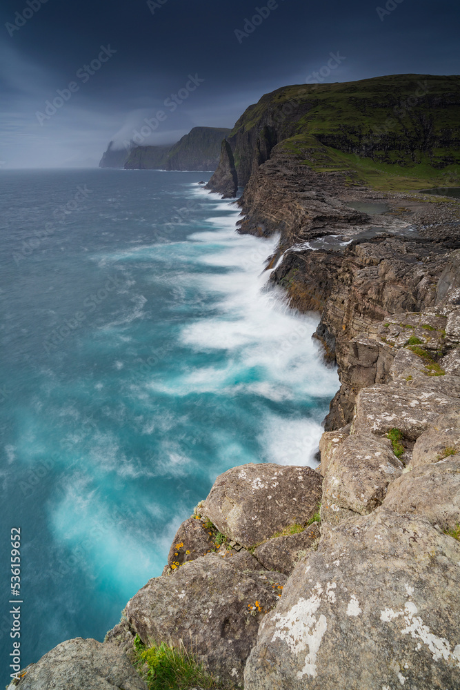 Trælanípan is one of the most renowned nature attractions in the Faroe Islands. From Trælanípan, in English the Slave Cliff, you can see the lake overlooking the salty North Atlantic ocean.